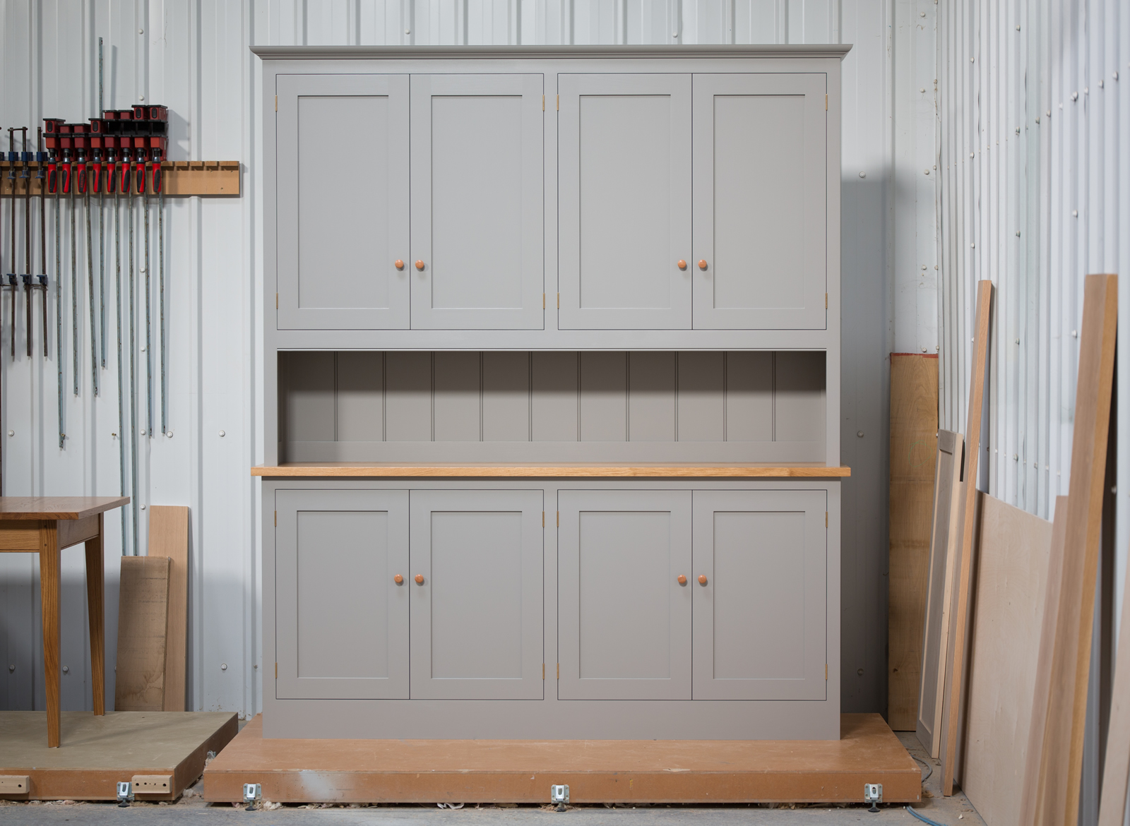 Dresser handpainted in Farrow & Ball Estate Egshell - 'Worsted'. Tulip wood frame with birch ply panels. Oak veneered and lipped birch ply shelves. Hand-turned hardwood knobs. Traditional brass butt hinges with bespoke soft close function. Adjustable 'hidden' levelling feet.