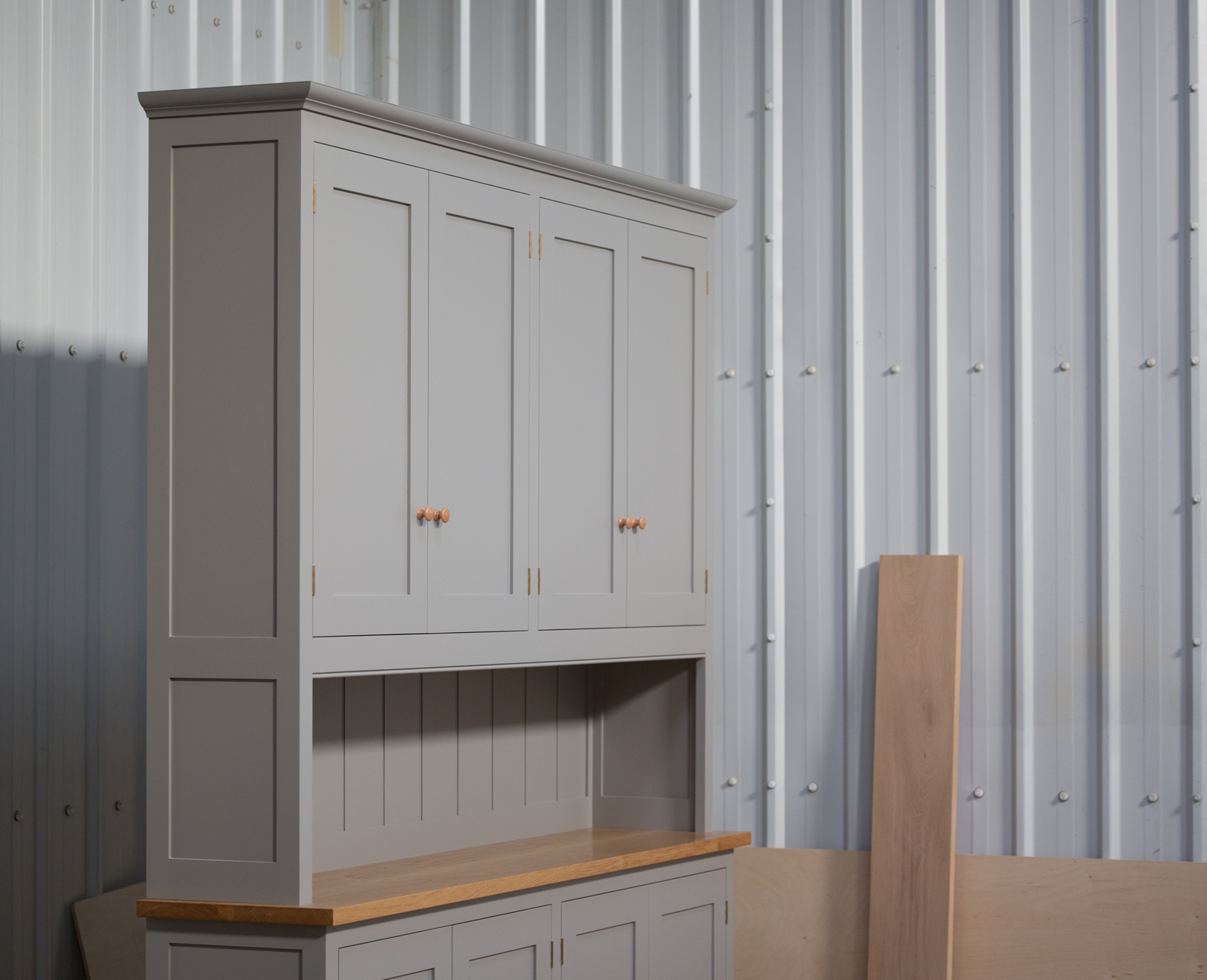 Dresser handpainted in Farrow & Ball Estate Egshell - 'Worsted'. Tulip wood frame with birch ply panels. Oak veneered and lipped birch ply shelves. Hand-turned hardwood knobs. Traditional brass butt hinges with bespoke soft close function. Adjustable 'hidden' levelling feet.