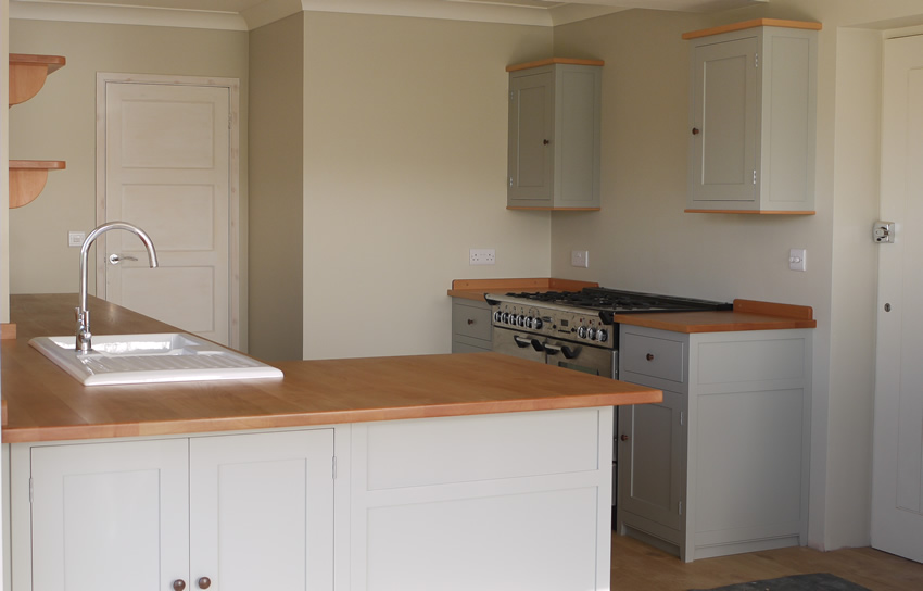 Shaker style kitchen. Birch plywood cabinets with hand painted hardwood frames (Farrow and Ball, Lamp Room Gray). Sink area with integral dishwasher, traditional ceramic inset sink and full stave beech top and upstand. Dovetailed drawers made of solid beech with painted hardwood fronts and walnut hand turned knobs.