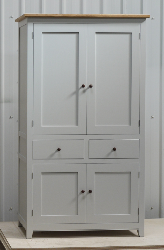 Larder cupboard handpainted in Farrow & Ball Estate Egshell - 'Pavilion Gray'. Tulip wood carcass with painted birch ply panels and maple faced birch ply shelves. Dovetailed oak drawers on high quality soft close runners. Oak spice racks. High quality solid brass hinges and adjustable brass shelf supports. Solid oak cornice and walnut knobs.