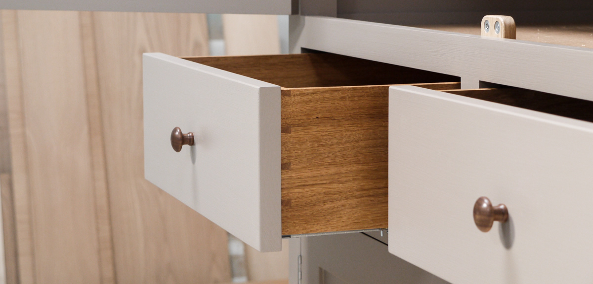 Larder cupboard handpainted in Farrow & Ball Estate Egshell - 'Charleston Gray'. Solid wood carcass with oak shelves, dovetailed drawers & spice racks. High quality solid brass hinges & shelf supports. Oak cornice & walnut knobs.