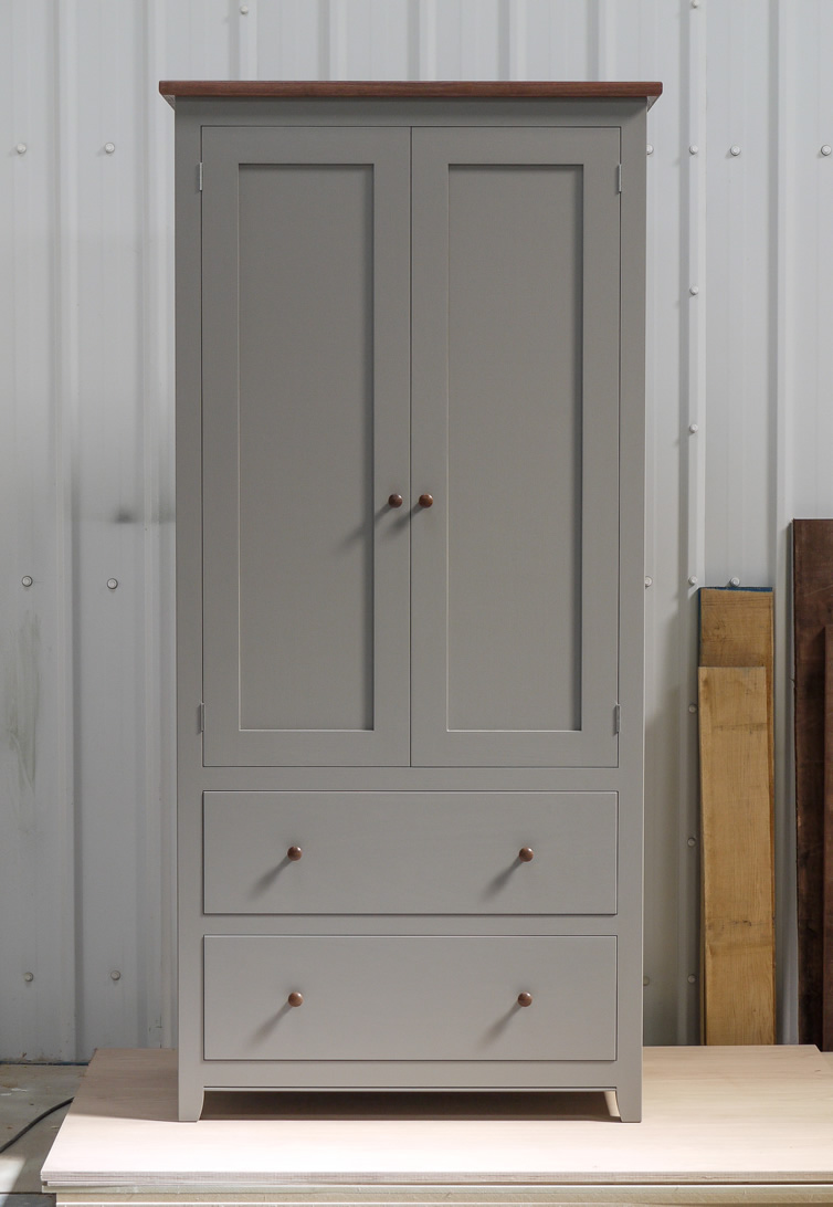 Larder cupboard handpainted in Farrow & Ball Estate Egshell - 'Mole's Breath'. Tulip wood carcass with birch ply panels and shelves. Dovetailed oak drawers on high quality soft close runners. Oak spice racks. Solid brass hinges and adjustable brass shelf supports. Solid walnut cornice and knobs.