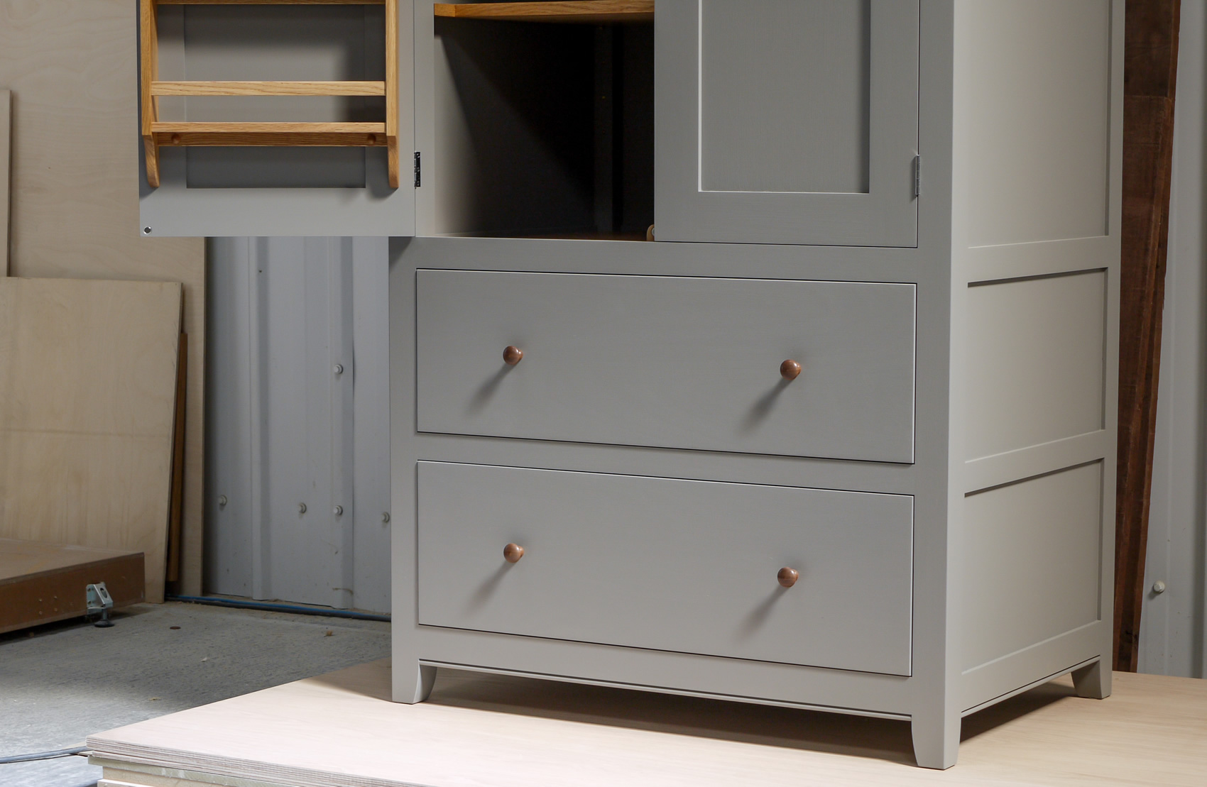 Larder cupboard handpainted in Farrow & Ball Estate Egshell - 'Mole's Breath'. Tulip wood carcass with birch ply panels and shelves. Dovetailed oak drawers on high quality soft close runners. Oak spice racks. Solid brass hinges and adjustable brass shelf supports. Solid walnut cornice and knobs.