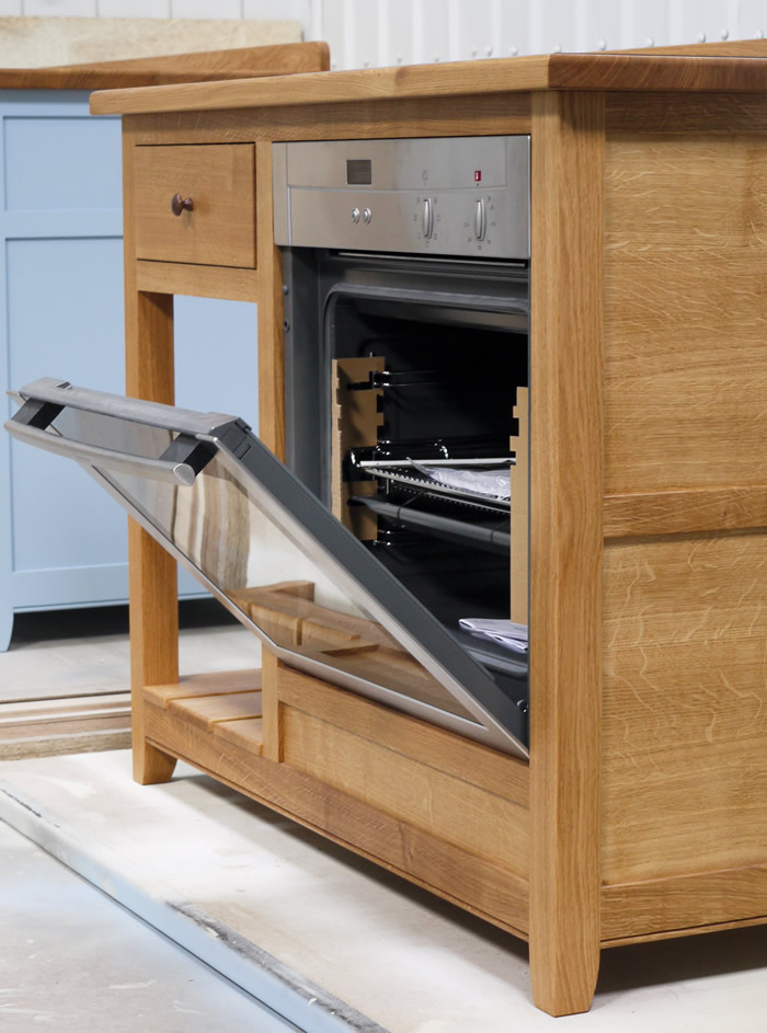 Freestanding hob and cooker unit in solid oak.