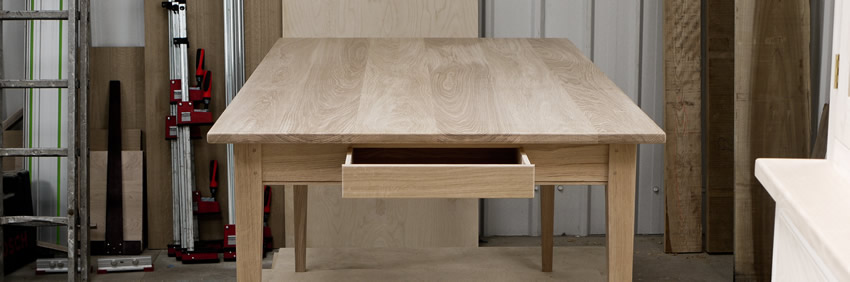 Oak Shaker style table with tapered legs and oak dovetailed drawer. The table is finished with hardwearing 'Osmo' hardwax oil.