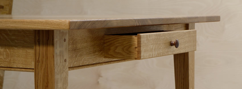 Oak Shaker style table with tapered legs and oak dovetailed drawer. The table is finished with hardwearing 'Osmo' hardwax oil.